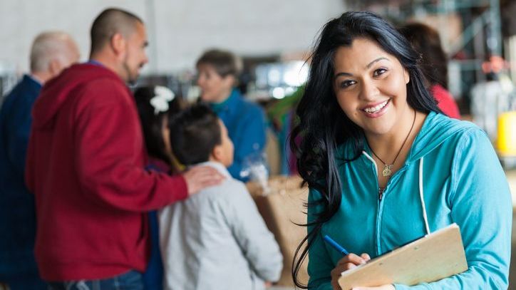 A nonprofit worker smiles during a community event that her organization is holding.