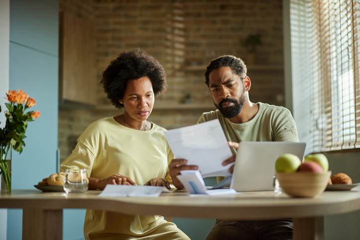 A couple researching strategies to save more for retirement.